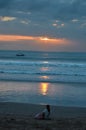 Woman Sitting on Beach Enjoying a Bali Sunset